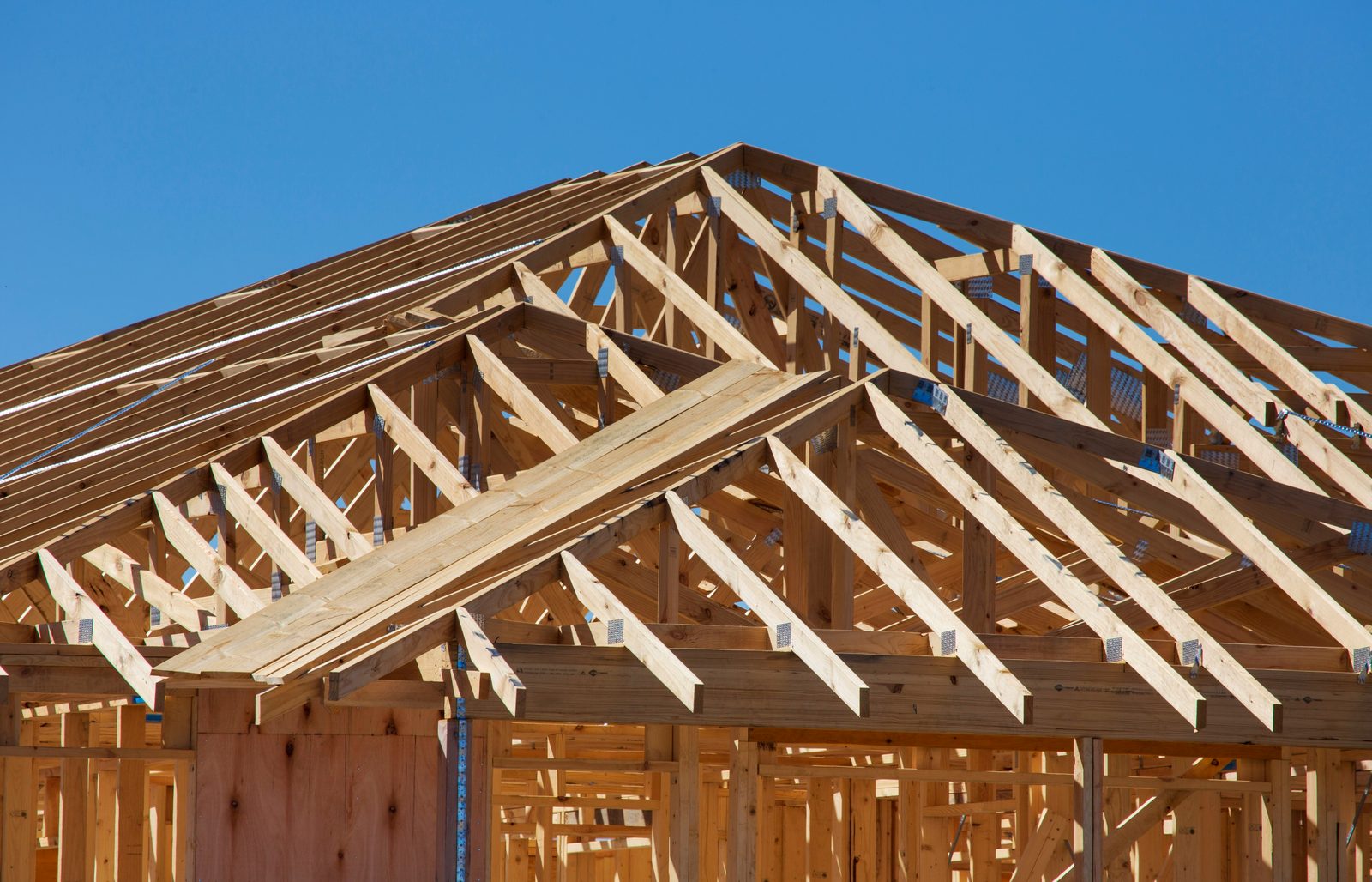New home under construction with wood framing and roof trusses